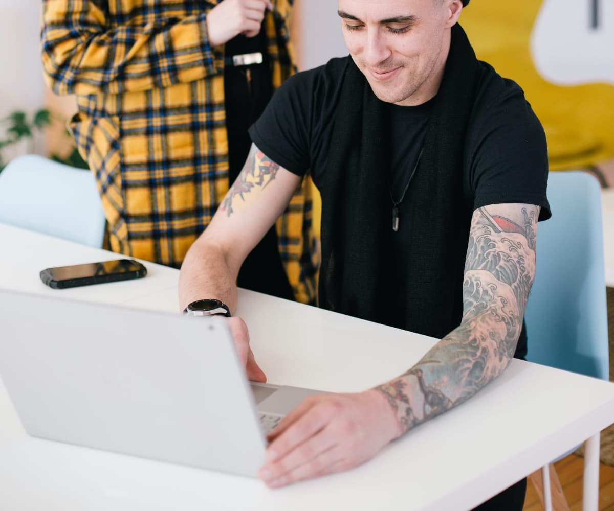 Image of man behind laptop